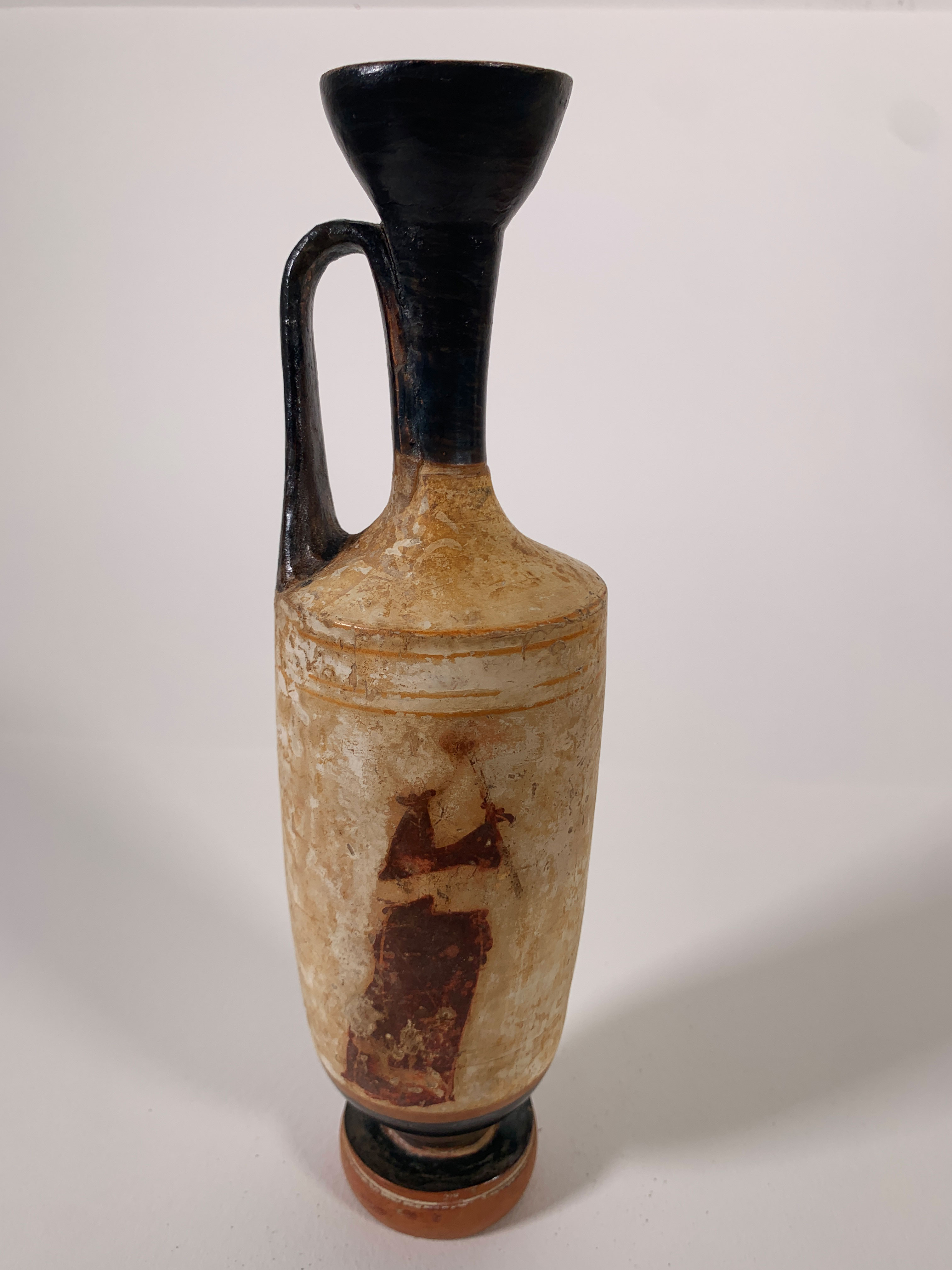 Attic White-Ground Lekythos depicting a mourning figure in matte polychrome on white slip, with black-glazed mouth and handle, circa 5th century BC